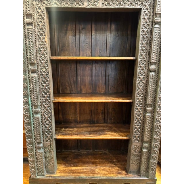This reclaimed hand-crafted carved wood Indian bookcase is repurposed from authentic antique architectural elements. It...