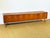 A stunning low sideboard in scandinavian design, dating from the 1960s, crafted from teak wood with warm tones and an...