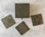 Set of 3 metal and wood coasters and matching storage box. Coasters and box lid have a textured or embossed metal foil...