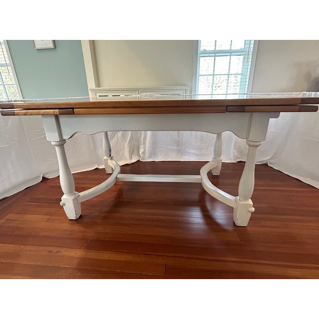 Large farm-house style draw-leaf dining table in beautiful condition. Solid wood top is in excellent condition. Leaves...