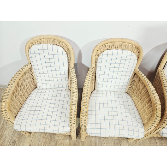 A set of four elegant, unique wicker armchairs from the renowned brand Domicil Möbel, dating back to the 1990s. The...