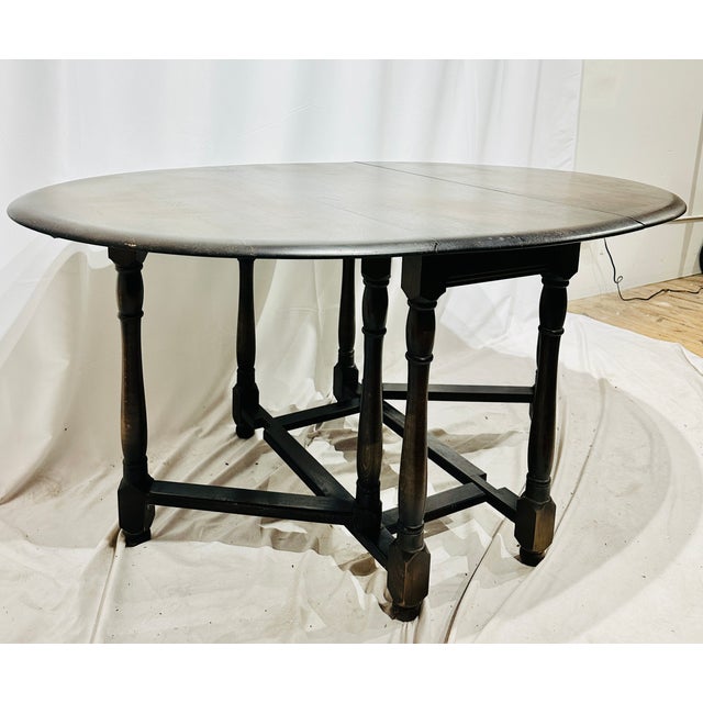 Early 20th century English Jacobean Revival solid oak antique gateleg drop-leaf table. Open: 60.5L 42.5D 29.75H Leaves...