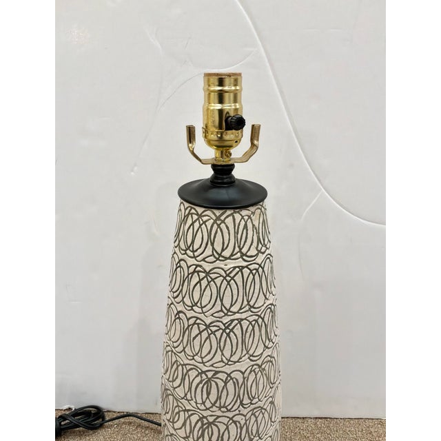 Stylish Currey & Co Cipher Lamp. Oval pattern on black round base. Showroom floor sample.