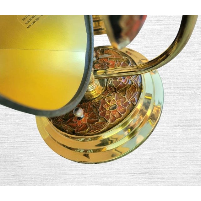 A beautiful vintage pair of brass and enamel Chinoiserie Closoinne wall sconces. The sconces feature a single arm which...