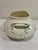 A charming vintage ceramic soup tureen featuring a soft cream glaze and elegant gold trim detailing. This classic serving...