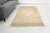 This is a vintage Turkish Oushak rug from the Mid 20th Century. The piece was hand-knotted.