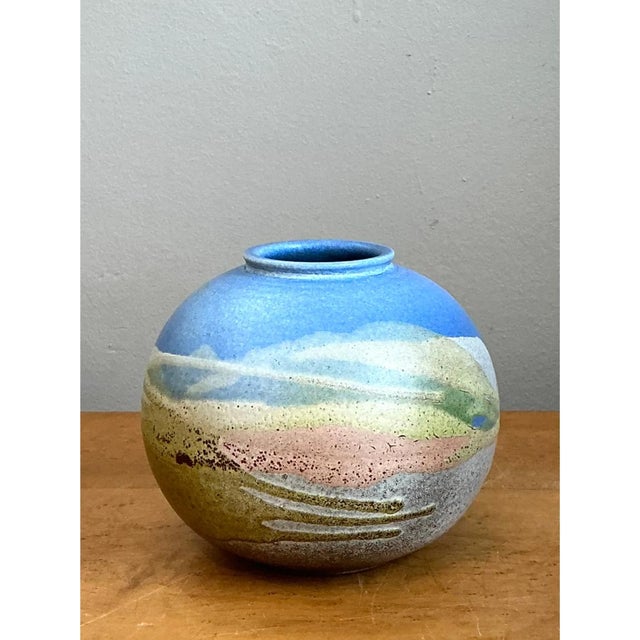 This vintage stoneware vase is a small landscape in clay, with a full, globular body that swells from a narrow, flat foot...