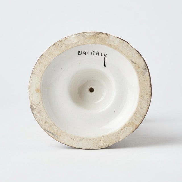 This piece is a classic example of Italian majolica, a tin-glazed pottery tradition dating back to the Renaissance. The...