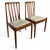 This pair of mid century teak dining chairs offers timeless style and comfort, perfect for enhancing your dining space...