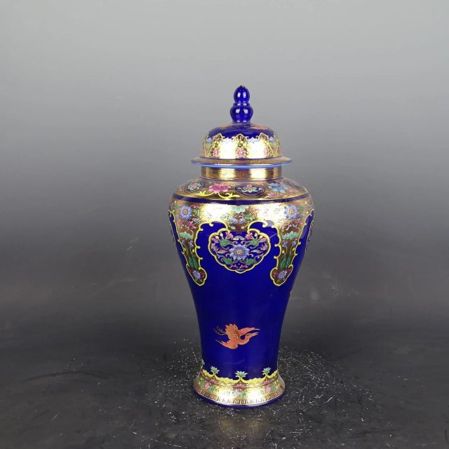 H-39cm,W-20cm This vintage porcelain ginger jar features a beautiful blue ground with hand-painted gold flowers, making it...