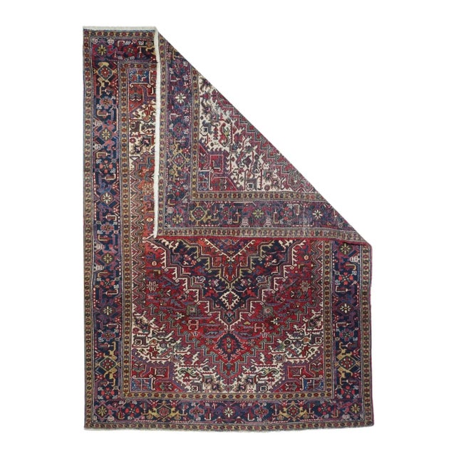 We love Heriz-area carpets and this characteristic example shows a stepped red field, cream corners, and a broadly stepped...