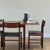A stunning mid-century Danish dining set comprising an extending dining table and four matching chairs, designed and...