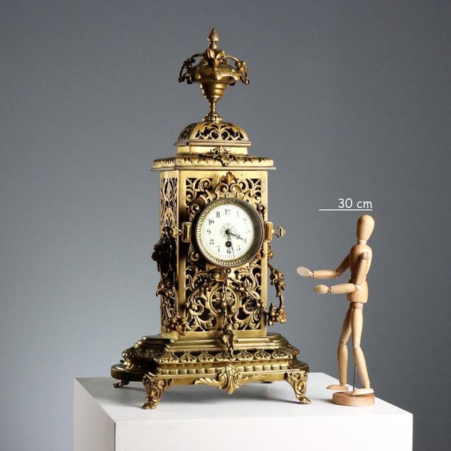 Eclectic-style table clock in richly perforated and chiseled bronze with leafy scrolls and festoons of leaves and fruit,...