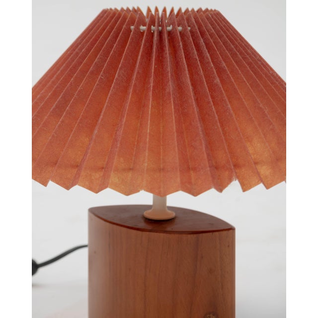 A table lamp or bedside lamp in a Japandi and Nordic retro style, inspired by the warmth of Mid-Century Scandinavian...