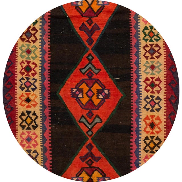 A beautiful hand-woven vintage Kilim runner with a brown field and multi-color accents in all-over medallion design. This...