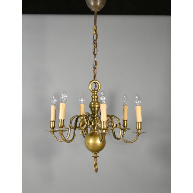 Six Arm Antique Dutch Bronze Chandelier A six arm chandelier with decorative out-swept arms holding candlelight bulbs...