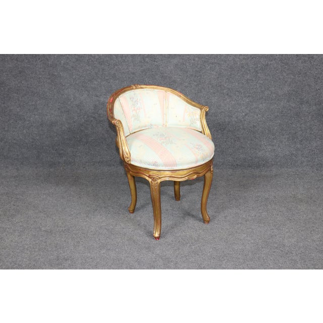 Add a touch of refined Parisian elegance to your interior with this exquisite swiveling French Louis XV style gilt chair...
