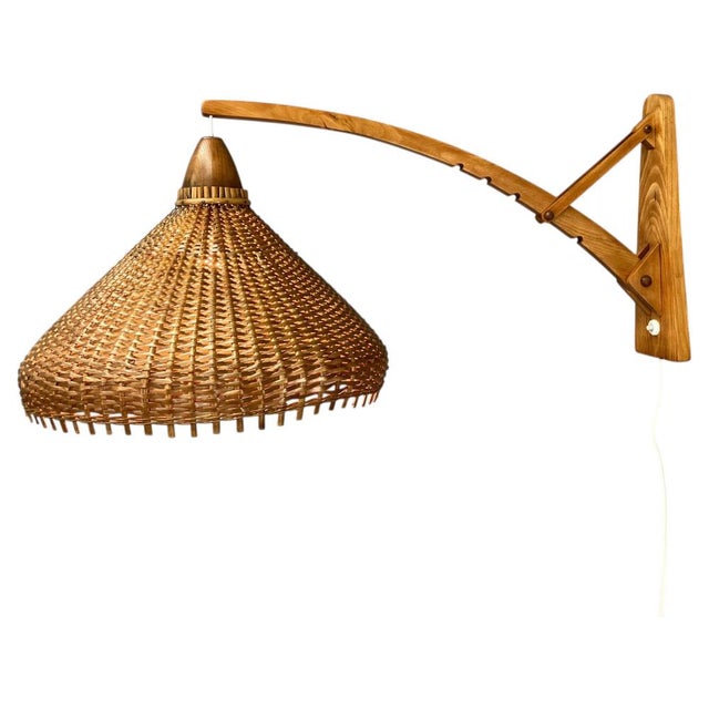 Adjustable mid-century wall lamp made and labeled by pokrok zilina in 1962. Made of wood and wicker. Restored, rewired:...