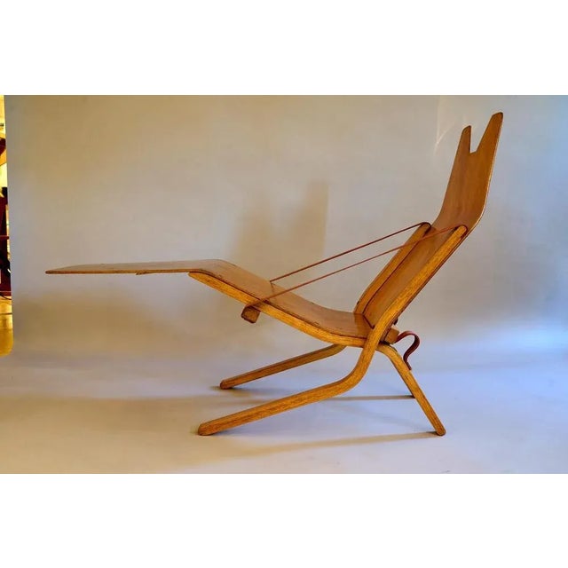 An early Ernest Race 'Neptune' chair. Beech plywood with the early brass fittings and webbing. Folds to an incredible 12cm...