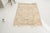 This is a vintage Turkish Oushak rug from the Mid 20th Century. The piece was hand-knotted.