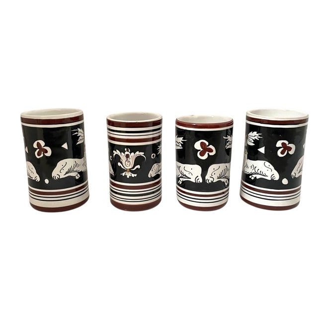 The VTG Antica Siena Italian Pottery Black White Deer Cups or Vases Set of 4 is a vintage set of round, glossy clay and...