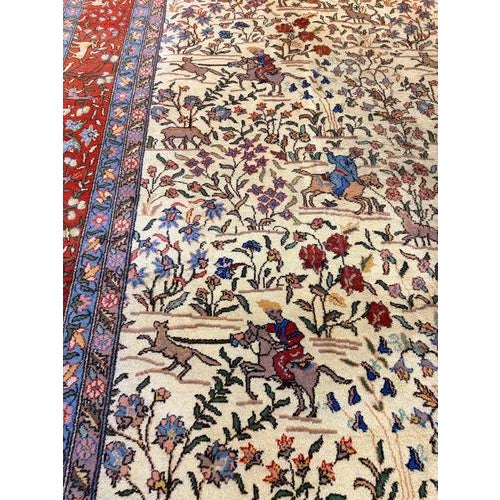 An exceptional, large-scale vintage Kashmar rug featuring an intricate polychrome hunting scene set against a classic...
