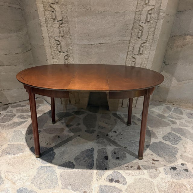 For your consideration, a vintage mid-century modern expandable oval wooden dining table. It begins as a compact round...