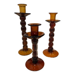 Set of Three Amber Colored Glass Candlesticks For Sale