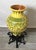 A vibrant yellow and green Italian earthen ware vessel with hand forged wrought iron stand. The glaze is hand decorated...