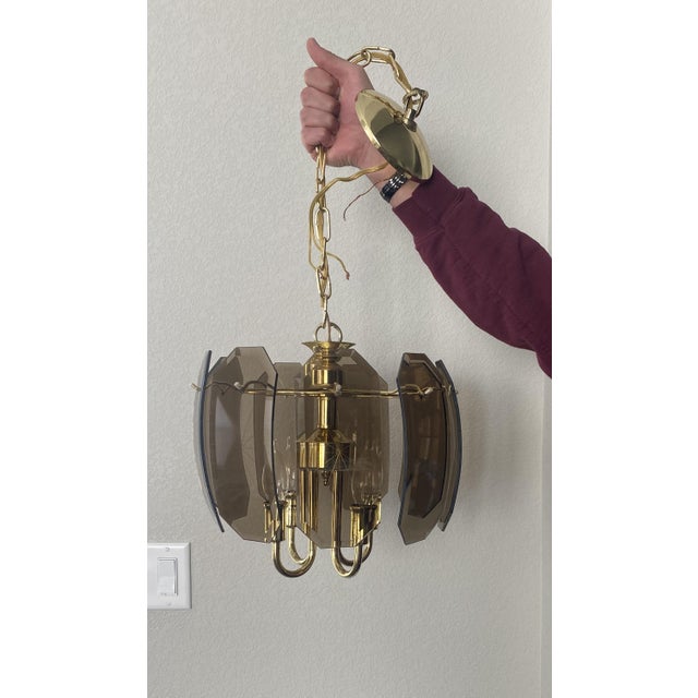 Beautiful vintage mid century modern style chandelier. A Catalina Lighting, smoked curved beveled glass chandelier. Comes...