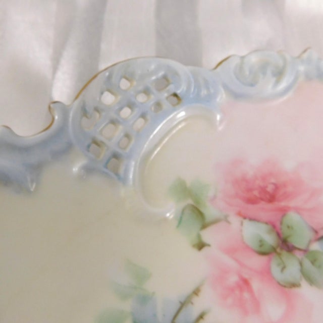 This is a white Leonard Vienna Austria plate with a baby blue edge with a reticulated detail and shaped porcelain edge...