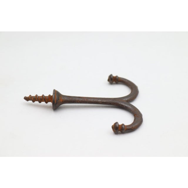 Vintage ceiling mount double arm hook made of cast iron with a black finish and screw top. The original mounting screws...