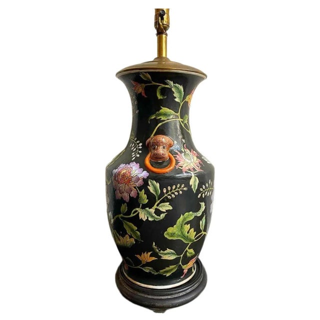 Fabulous, large scale vintage lamp. Deep black with floral details and rare, leopard like foo dog accents. Measurements of...