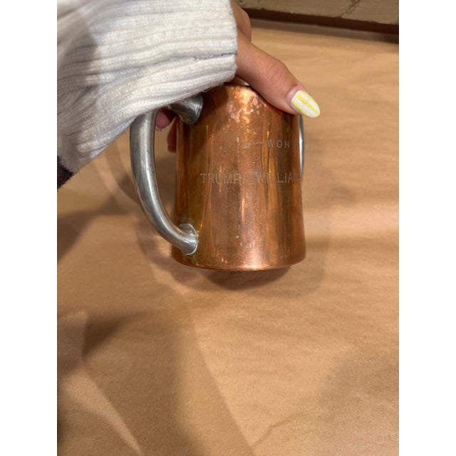 This is a 1910s Double-Handed Copper Trophy Cup. It has an engraving on it that says "Won by Trump William S Mitchell" on...