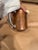 This is a 1910s Double-Handed Copper Trophy Cup. It has an engraving on it that says "Won by Trump William S Mitchell" on...