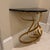 The console table is identified as the Cyan Design Ribbon Console Table, featuring a distinctive gold, ribbon-shaped metal...