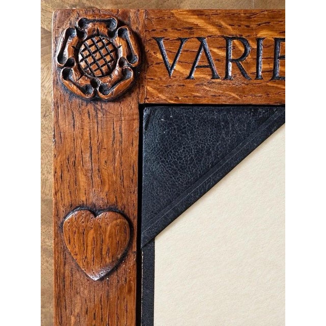 A carved lizard climbs the lower left corner of this oak blotter frame by martin dutton, known as ‘lizardman’. Dutton...