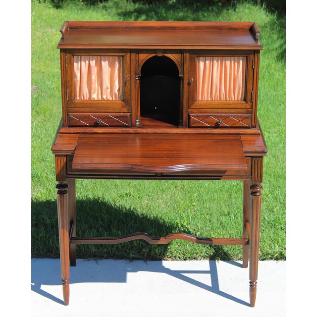 Elegant and beautifully crafted, this vintage Louis XVI style mahogany secretary desk combines timeless French design with...