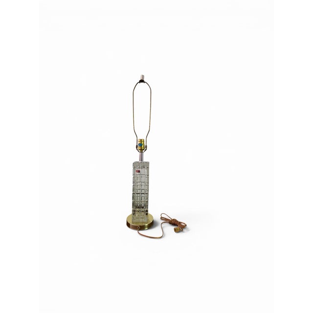 A striking vintage architectural table lamp featuring a solid, faceted crystal column composed of stacked blocks....