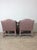 This pair of vintage upholstered chairs feature pink polka dot upholstery throughout, low back and rounded arm rests with...