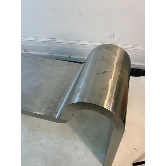 Sculptural Modern Curved Design Bench Composed Of Polished Steel Attributed To Karl Springer Designed 1980's-1990's.