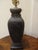A beautiful bronze finished lamp with Classical Chinese scenes and a wood base. Fine Quality.