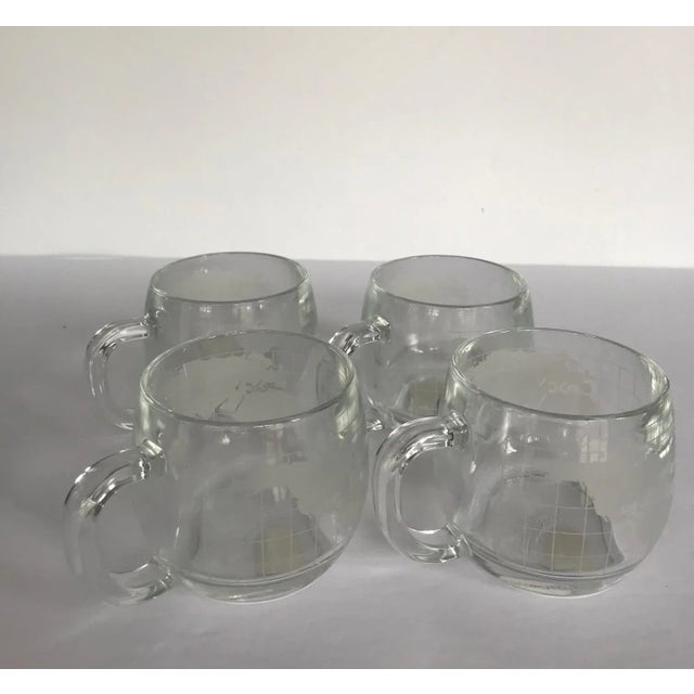 Set of 4 vintage Colonial Cupboard world map coffee mugs made for Nestle Co. Heavy clear glass mugs etched with world map....