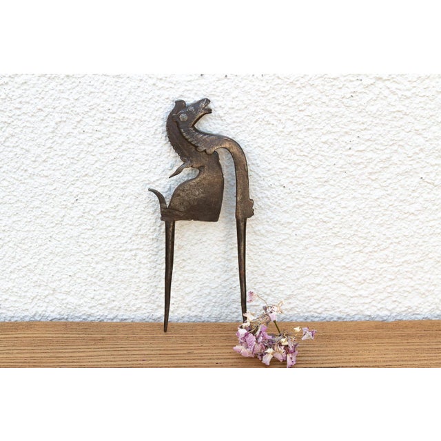 An exceptional Early 19th-century North Indian hand-cast bronze and iron betel nut cutter (Sarota), featuring a...