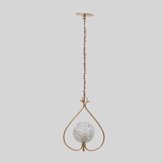 Stunning brass and glass pendant light from France, 1950s. Original round textured glass shade suspended on a brass...