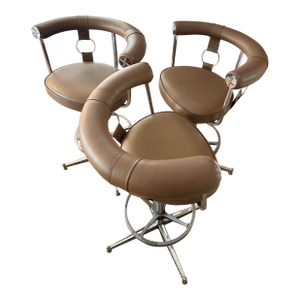 A Set of 3 Swivel Bar Stools Attributed to Daystrom Furniture of Boston, Featuring a Taupe Faux Leather Upholstery With Chrome Frames, Circa 1970s.