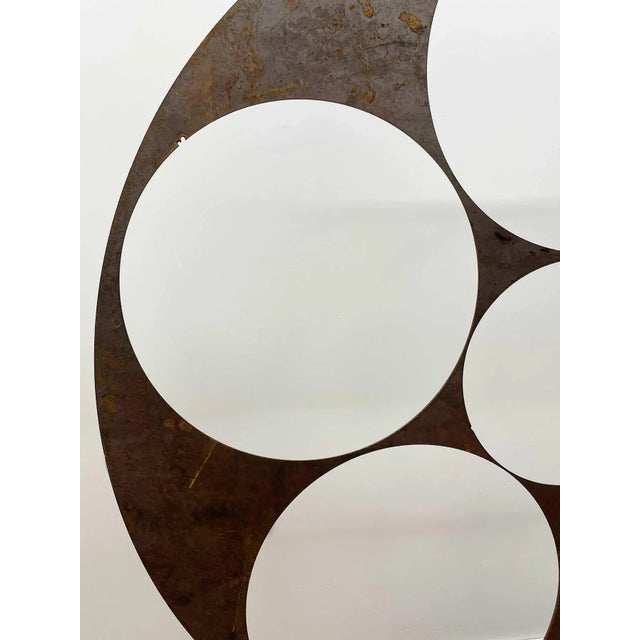 Large 20th century contemporary iron abstract sculpture on iron base. Surface has a distressed finish. Base is 12”...