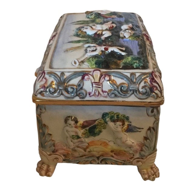 10” long 6.5” high 6.5” wide, Antique Capodimonte Italy Raised Cherub Garden Jewelry Box. Completely Hand painted and gilt...