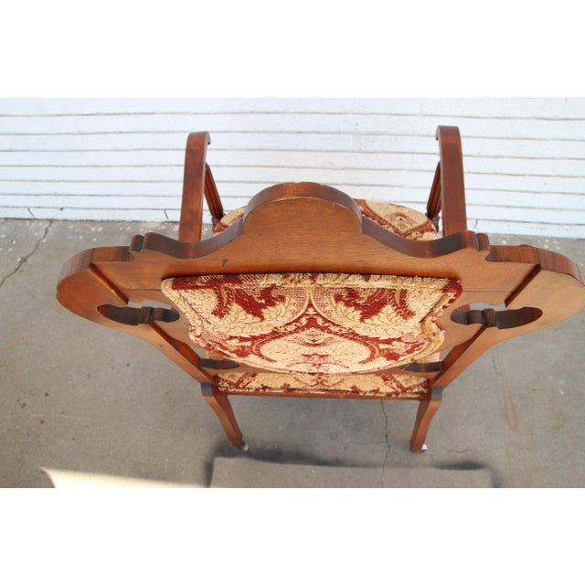 This is. a nicely upholstered armchair. The front and the back is upholstered. The frame of the chair is made of walnut....