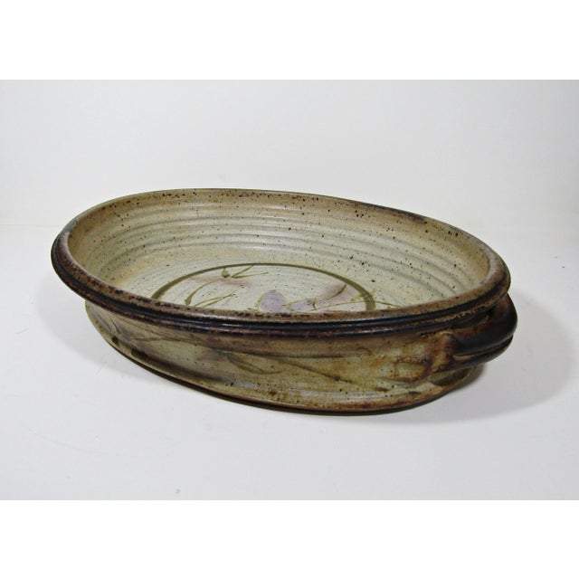 Elevate your dining experience with this stunning signed studio art pottery casserole serving dish. Handcrafted by a...